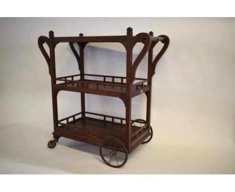 Vintage hardwood three-tier drinks trolley with spoked back wheels and solid front  wheels, also with two towel hangers, over