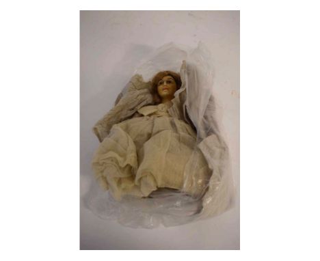 Vintage doll with waxed head and painted features, with bisque arms and a gauze style  dress, 26cms tall