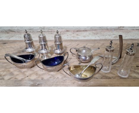 Assorted silver condiment pieces to include three pepper pots / casters, two salts, both with cobalt blue liners, a non-match