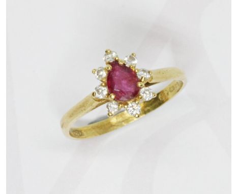 An 18ct gold diamond and ruby cluster ring, the cluster measuring approximately 10.60mm x 8.75mm, 18ct gold import marks, gro