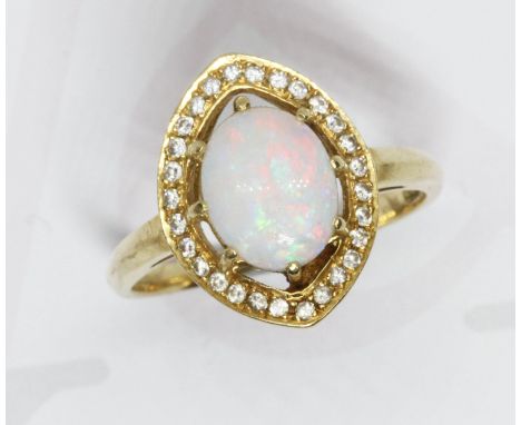 An opal and diamond cluster ring, the central opal cabochon measuring approximately 9.86mm x 7.85mm, depth 2.81mm, surrounded