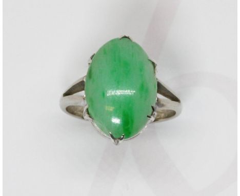 A jadeite jade cabochon ring, the six claw set stone measuring approximately 15mm x 10mm, depth 3.43mm, white metal band unma