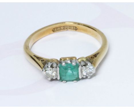 An emerald and diamond ring, the central square stone measuring approximately 4mm x 4mm, depth 3.44mm, band marked '18CT&amp;