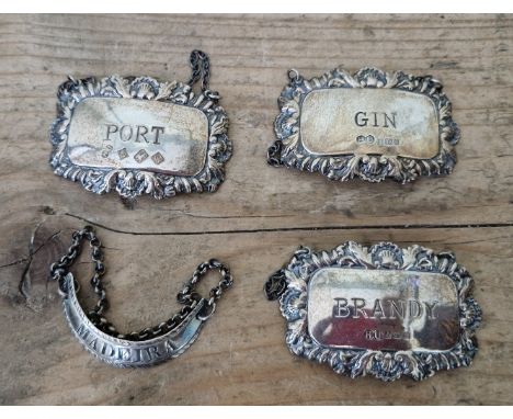 Three hallmarked silver decanter / wine labels to include Port, Gin and Brandy, Birmingham, Hampton Utilities, two dated 1976