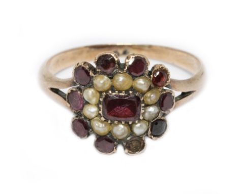 A 19th century garnet and split pearl cluster ring, unmarked, gross weight 2.5g, size P. Condition - one stone missing, one n