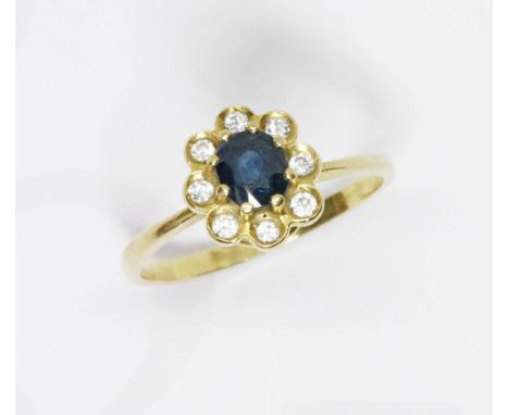 An 18ct gold diamond sapphire cluster ring, the flower head cluster measuring approximately 10.18mm x 9.24mm, hallmarked 18ct