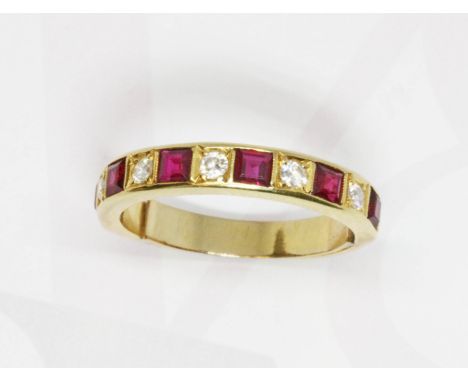A ruby and diamond half eternity ring, yellow metal band unmarked, gross weight 4.4g, size O.  Condition - re-sized and also 