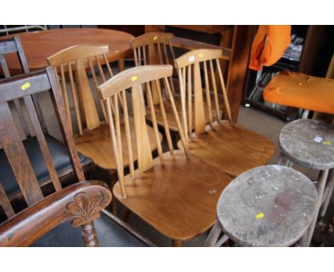 A set of four stick back dining chairs 