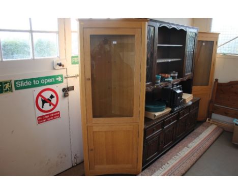 A light oak and glazed corner cabinet