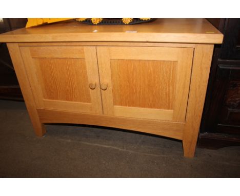 A light oak low two door cupboard