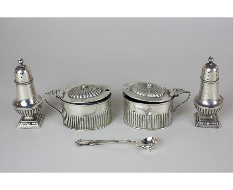 A pair of Victorian silver mustards, maker William Devenport, Birmingham 1900, half reeded body with blue glass liners, toget