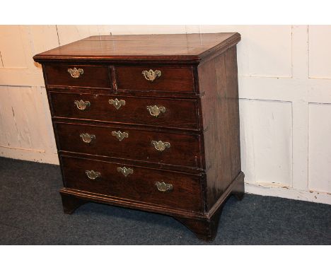 A George III oak chest of two short over three long drawers, on bracket feet, 84cm
