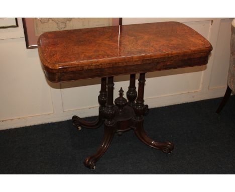 A Victorian style burr walnut card table, rectangular shape with fold over top and green baize lining on four column pedestal