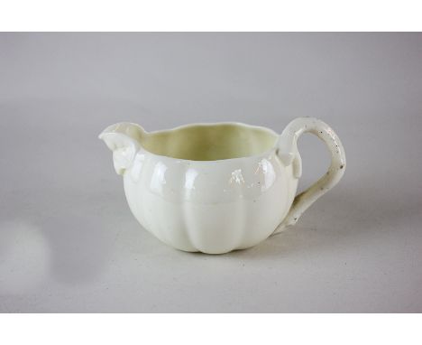 A Royal Worcester porcelain melon form milk jug with naturalist handle and spout