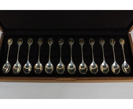 A cased set of twelve Elizabeth II silver spoons by John Pinches, London 1975, each spoon with a different bird, in 24ct gold