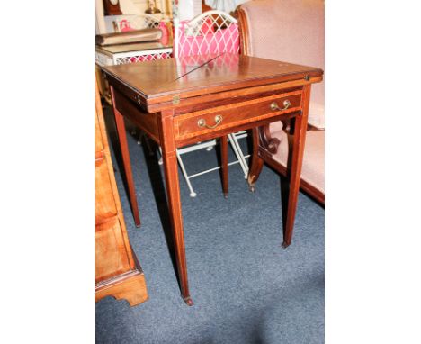 An Edwardian inlaid mahogany envelope card table, with four section fold out top, on square tapered legs and casters, 56cm