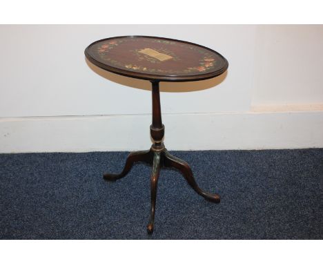 A painted mahogany and occasional table, decorated with harp and music, with floral border, on pedestal stem and four curved 