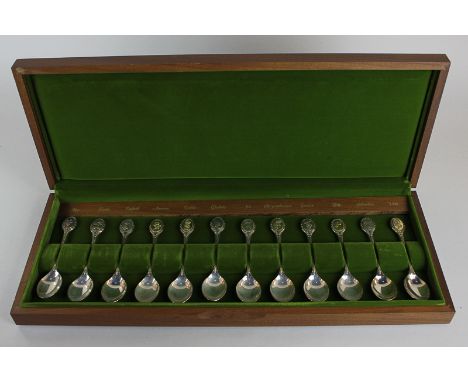 A cased set of twelve Elizabeth II silver spoons by John Pinches, Sheffield 1973, each spoon with a different flower finial, 