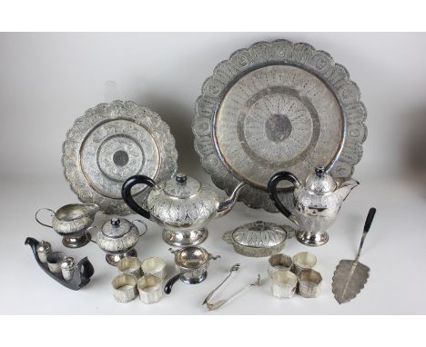 A Malayan Kelantan white metal tea service, comprising tea pot, hot water pot, milk jug, sugar bowl, tea strainer with stand,