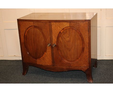 An Edwardian mahogany bow front cabinet with cross banded top and twin oval panelled doors, on splayed bracket feet, 95cm