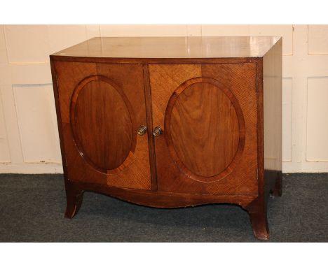 An Edwardian mahogany bow front cabinet with cross banded top and twin oval panelled doors, on splayed bracket feet, 95cm