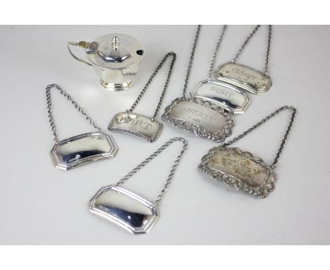 Seven silver decanter labels including a pair, Port and Sherry, with scroll borders, four octagonal with two blank, a single 