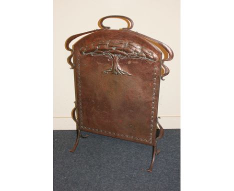 An Art Nouveau copper fire screen embossed with a stylized tree, 58cm