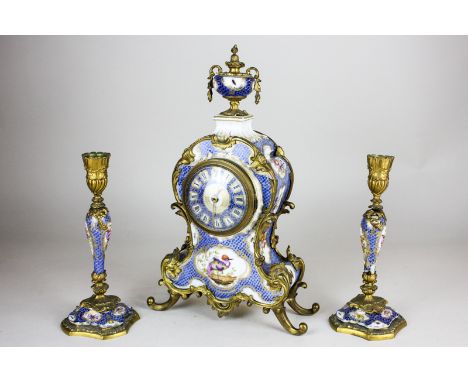 A 19th century French style ormolu and porcelain clock garniture, with Sevres style bird and floral panel decoration on blue 