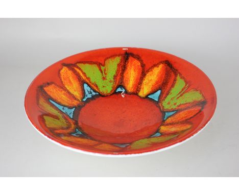 A Poole pottery shallow bowl in red, green, orange and turquoise pattern, initialled AF to base 26.5cm diameter