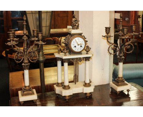 A 19th century French clock garniture, the drum cased movement marked Medaille D'Arge, striking on a bell, the painted white 