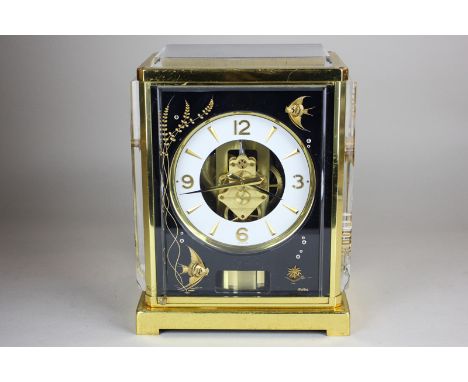 A Jaeger-LeCoultre Atmos 'Marina' clock with white circular dial in gilt metal framed case with black panels, the front and s