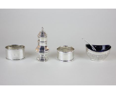 A George V silver pepper, maker William Base, Birmingham 1919, a silver salt with blue glass liner by Joseph Gloster Ltd, Bir