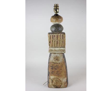 A 1960's Troika style stoneware lamp base, modelled as a pile of stone blocks and pebbles, some with inscribed markings 53.5c