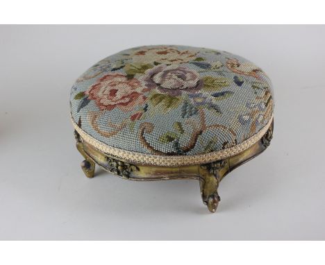 A circular giltwood footstool with tapestry upholstered top