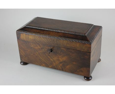 A George III mahogany tea caddy, gadrooned border, lid enclosing two canisters, on bun feet 32cm 