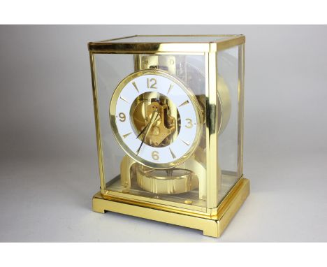 A Jaeger-LeCoultre Atmos clock, with white circular dial, in gilt metal case with clear glass panels, 22cm high