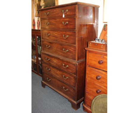 A George III mahogany tallboy chest on chest, top with four drawers and lower section with three drawers, with brass swan nec