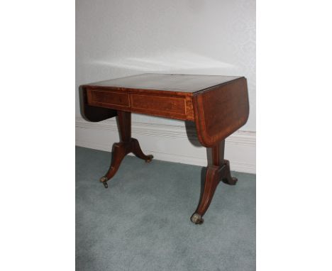 A Regency 'fiddle back' mahogany sofa table, the top with satinwood band and boxwood and ebony stringing, with two end drop f