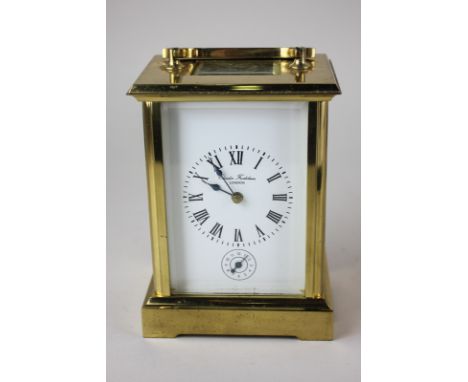 A Charles Frodsham brass and bevelled glass cased carriage clock, the white enamel face with Roman numerals and subsidiary di