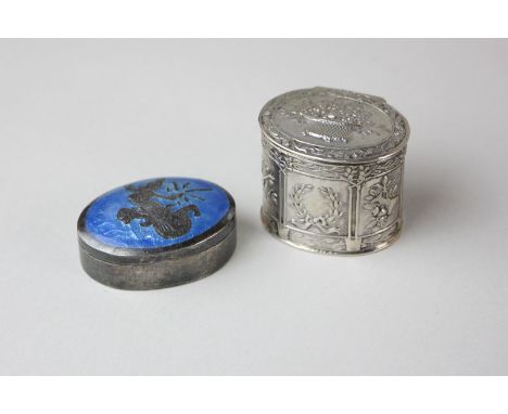 A Siam sterling silver and enamel oval pill box with a figure to the lid, and another small oval box cast with decorative pan