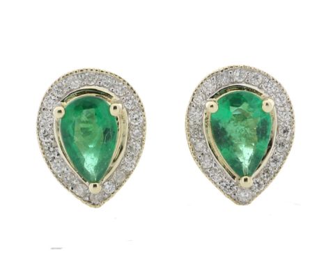These simple yet classic style stud earrings feature a pear shaped emerald surrounded by a halo of round brilliant cut diamon