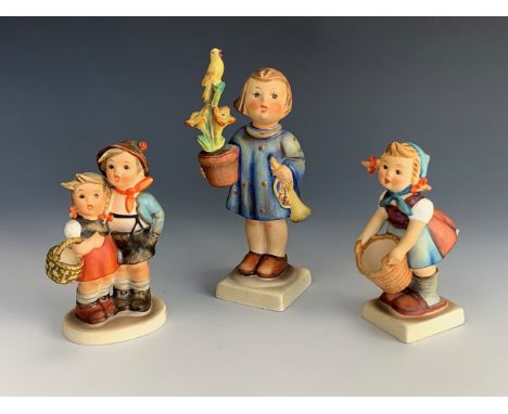 Three Hummel figures, tallest 14 cm.