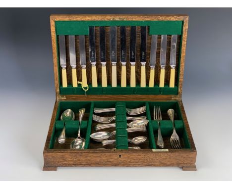 A vintage Harrods of London oak cased canteen of electroplate cutlery, for six, in the Old English pattern