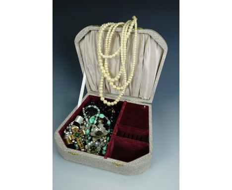 A vintage jewellery box containing a quantity of costume jewellery, including a 1960s cruciform pendant on chain, three vinta