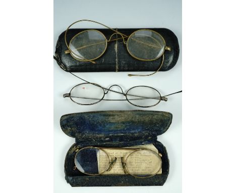 A pair of pince-nez glasses, and two pairs of vintage spectacles