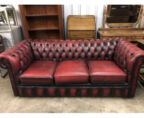 A late 20th Century red hide upholstered Chesterfield sofa, 195 cm x 86 cm x 75 cm high, seat 45 cm high, 150 cm wide, 55 cm 