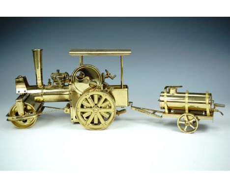 A Wilesco "Old Smoky" live steam model road roller and water bowser