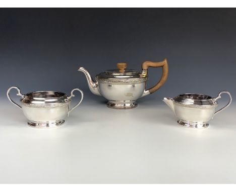 A vintage three-piece electroplate tea set, of hemispherical form, decorated with a Celtic strapwork border