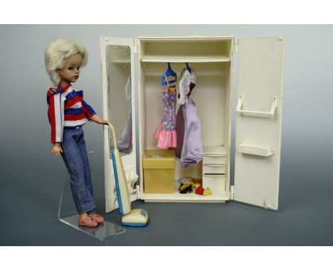 A vintage Sindy doll, wardrobe, house etc 