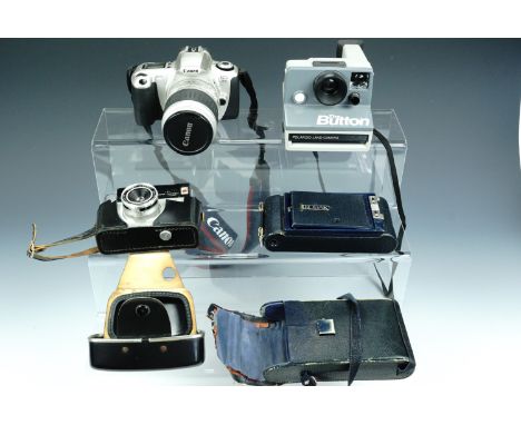 A Kodak, Canon EOS 300, Polaroid "The Button" and Halina Simplette FC cameras